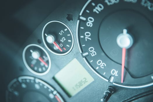 Close up picture of car dashboard with instruments and tachometer