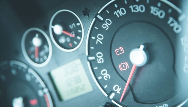 Close up picture of car dashboard with instruments and tachometer