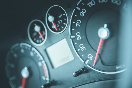 Close up picture of car dashboard with instruments and tachometer