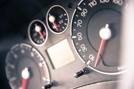 Close up picture of car dashboard with instruments and tachometer