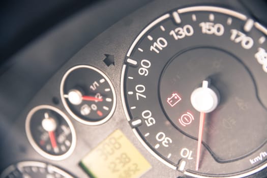 Close up picture of car dashboard with instruments and tachometer