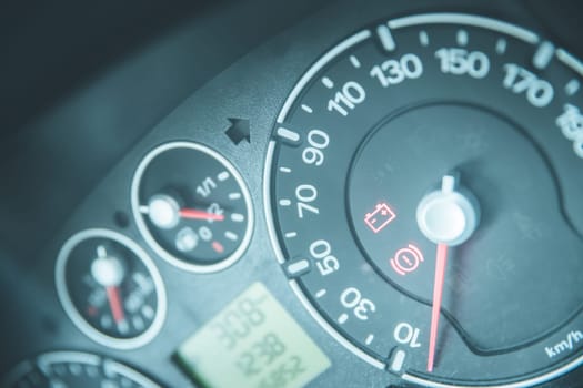 Close up picture of car dashboard with instruments and tachometer