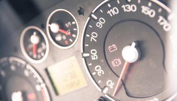 Close up picture of car dashboard with instruments and tachometer