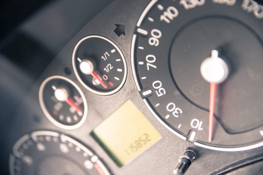 Close up picture of car dashboard with instruments and tachometer