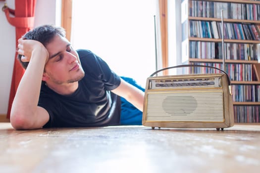 Young man listeining to an retro radio