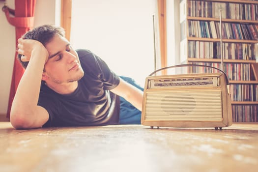 Young man listeining to an retro radio
