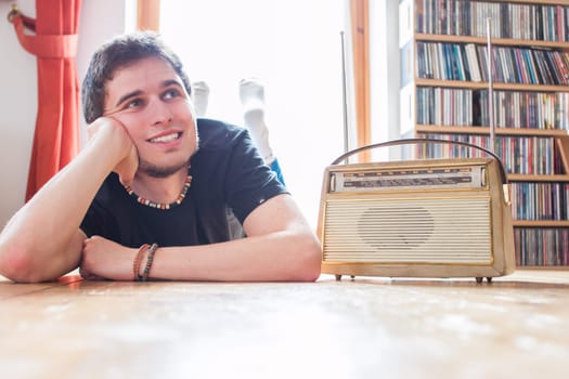 Young man listeining to an retro radio