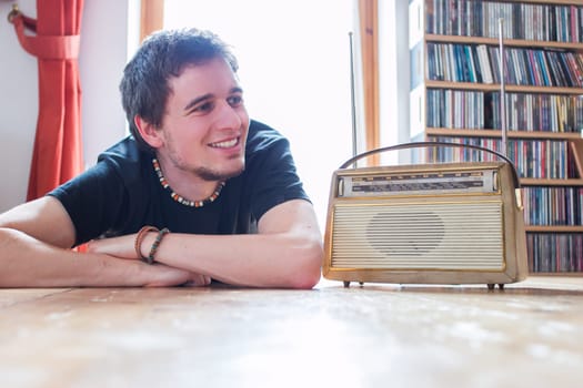 Young man listeining to an retro radio