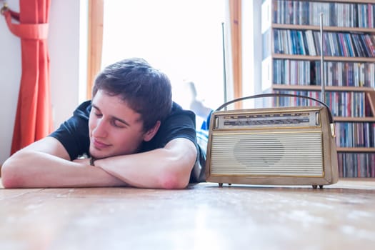 Young man listeining to an retro radio