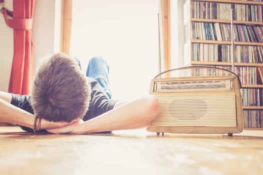 Young man listeining to an retro radio