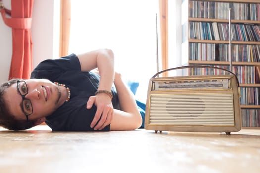 Young man listeining to an retro radio