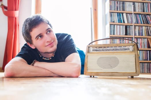 Young man listeining to an retro radio