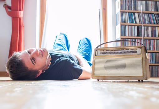 Young man listeining to an retro radio