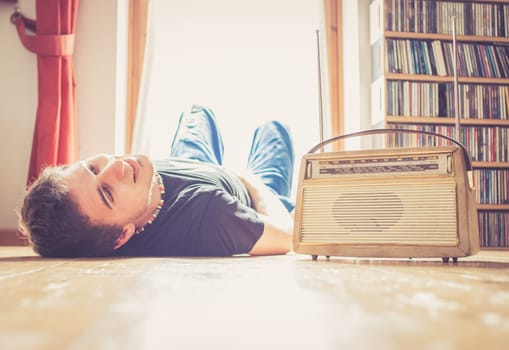 Young man listeining to an retro radio