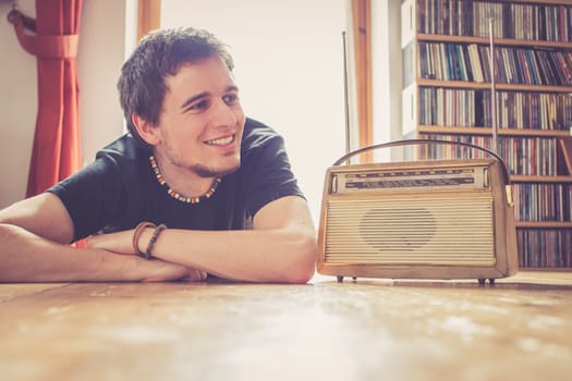 Young man listeining to an retro radio