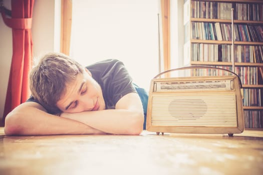 Young man listeining to an retro radio