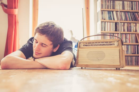 Young man listeining to an retro radio