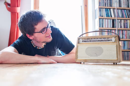 Young man listeining to an retro radio