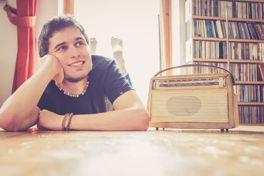 Young man listeining to an retro radio