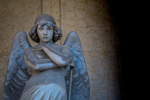 GENOA, ITALY - June 2020: antique statue of angel (beginning 1900, marble) in a Christian Catholic cemetery - Italy