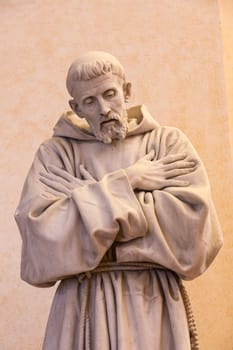 Assisi village in Umbria region, Italy. Statue of St. Francis. The town is famous for the most important Italian St. Francis Basilica (Basilica di San Francesco)