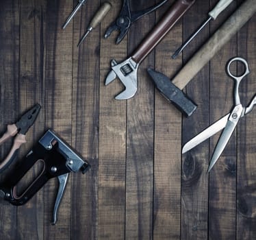 Old vintage tools on wood table background. Flat lay.