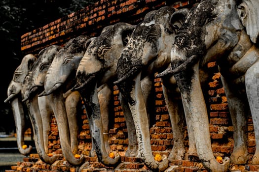 Wat Sorasak chedi surrounded by elephants. CHEDI WAT CHANG LOM (Elephant Temple).Sukhothai Historical Park covers the ruins of Sukhothai. Stupa decorated with elephant reliefs in the temple ruins