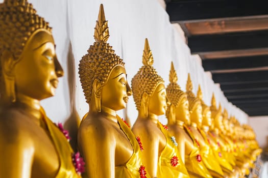 Seated Golden Buddha Statues in a row at Wat Phutthaisawan, Temple Of The Reclining Buddha Ayutthaya Thailand