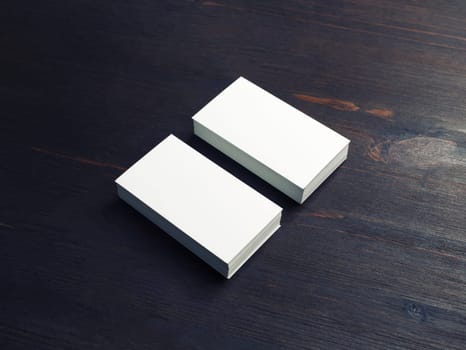 Photo of blank white business cards on wood table background. Copy space for text.