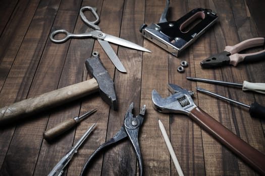 Set of different tools on vintage wood table background.