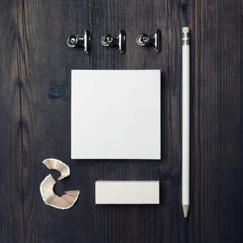 Blank stationery template for placing your design. Blank notes, pencil and eraser on wooden background. Mockup for branding identity. Top view. Flat lay.