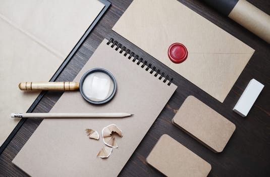 Photo of blank vintage stationery set on wooden background. Corporate identity template. Responsive design mockup. Flat lay.