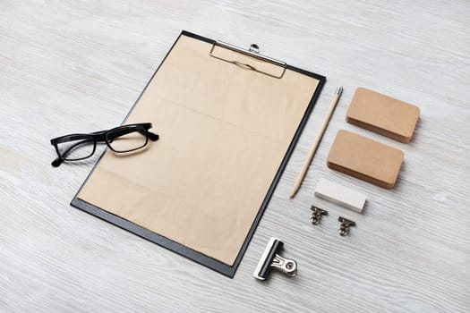 Blank vintage corporate stationery set on light wooden background. Template for branding identity.