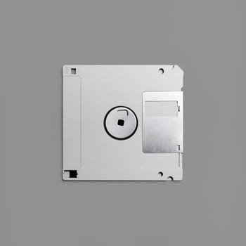 Floppy disk on gray paper background. Gray diskette. Top view. Flat lay.