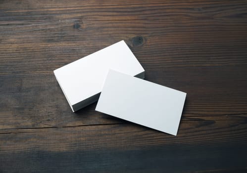 Blank business cards on wood table background. Mockup for branding identity. Template for graphic designers portfolios.