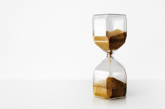 Hourglass on light background with copy space. Time Running Out.