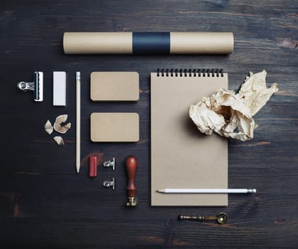 Blank kraft stationery set on wooden background. ID template. Mockup for branding identity for designers. Flat lay.