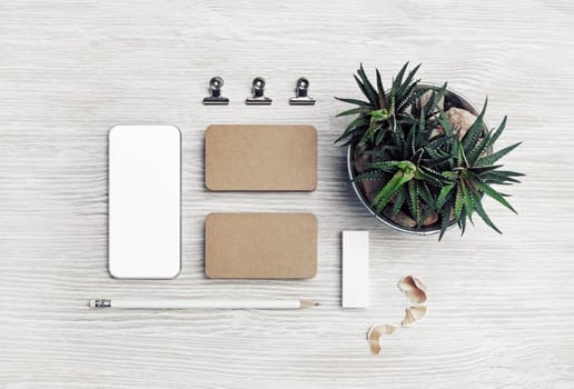 Blank stationery template on light wooden background. Corporate identity set. Top view. Flat lay.