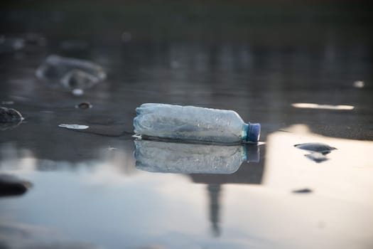 Environmental pollution: plastic bottle on the beach