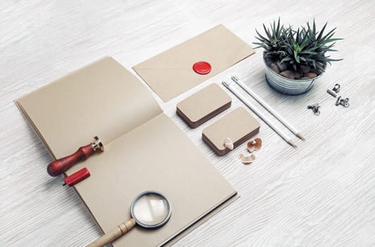 Blank vintage stationery and ID template on light wood table background. Mock-up for branding identity for designers.