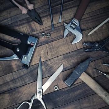 Vintage used work tools on old wood table background. Top view. Flat lay.