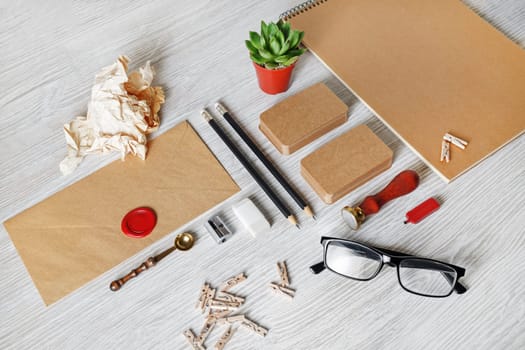 Blank kraft stationery set on light wooden background. Template for branding identity. For graphic designers presentations and portfolios.