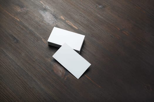 Blank business cards on wood table background. Branding mockup.