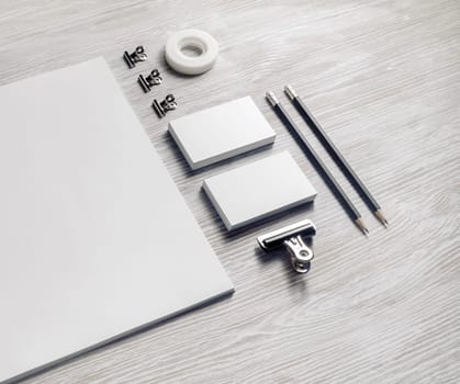 Brand identity mockup. Blank corporate stationery set on light wood table background.