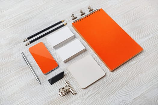 Blank corporate identity set on light wooden background. Mockup for design presentations and portfolios.