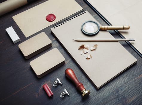 Blank kraft business stationery set on wood table background. Corporate identity template. Branding mock-up.