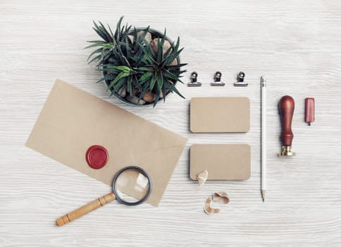 Blank retro stationery on light wood table background. Mockup for your design. Top view. Flat lay.