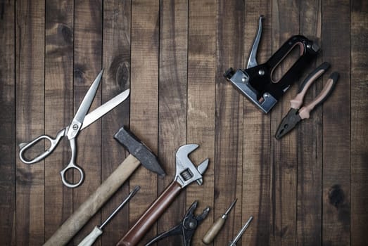 Used work tools on wooden background. Top view. Flat lay.