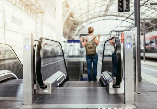 Travelling scene at a train station: young girl and a stairway