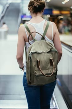 Travelling scene at a train station: young girl and a stairway